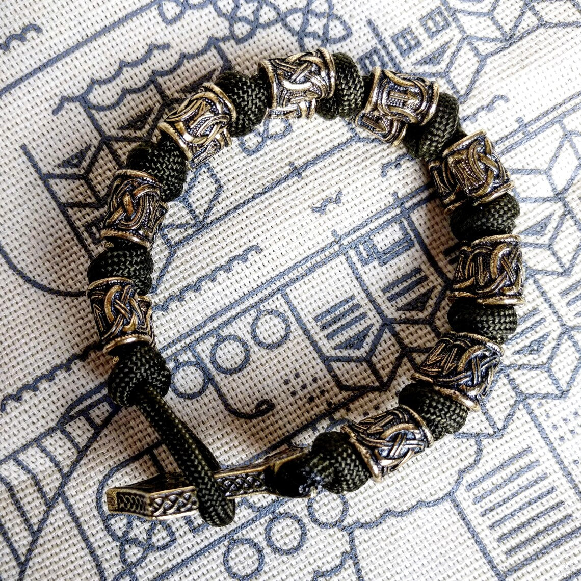 Runic bracelet "VIKING" from a paracord with a clasp "THOR'S HAMMER". Runes "teyvaz" and "algiz". Viking style.