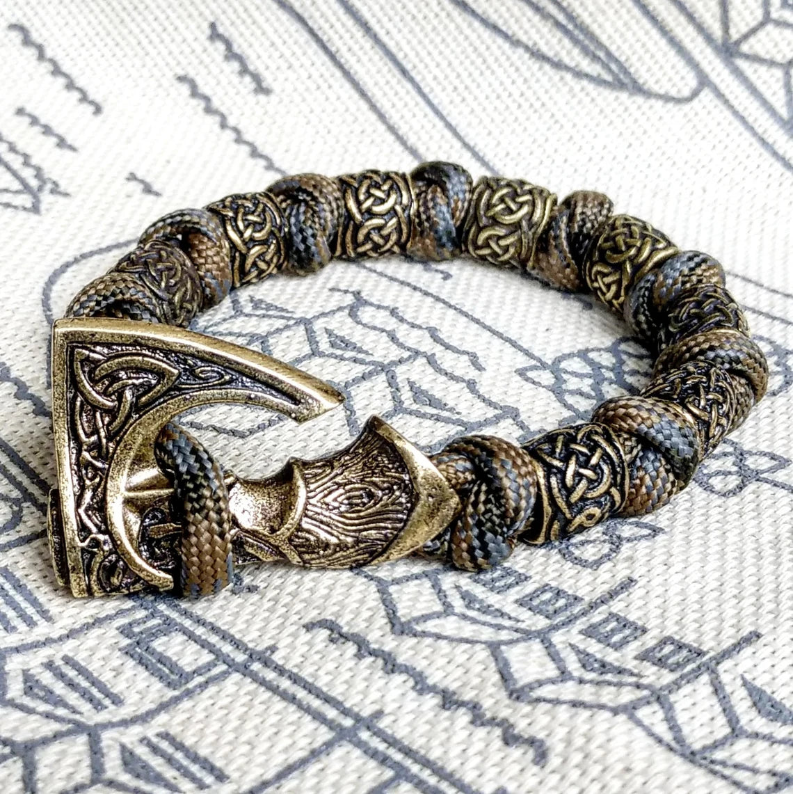 Viking bracelet made of paracord, Celtic knots and original beads made of brass with the image of ancient Scandinavian patterns. Mens style.