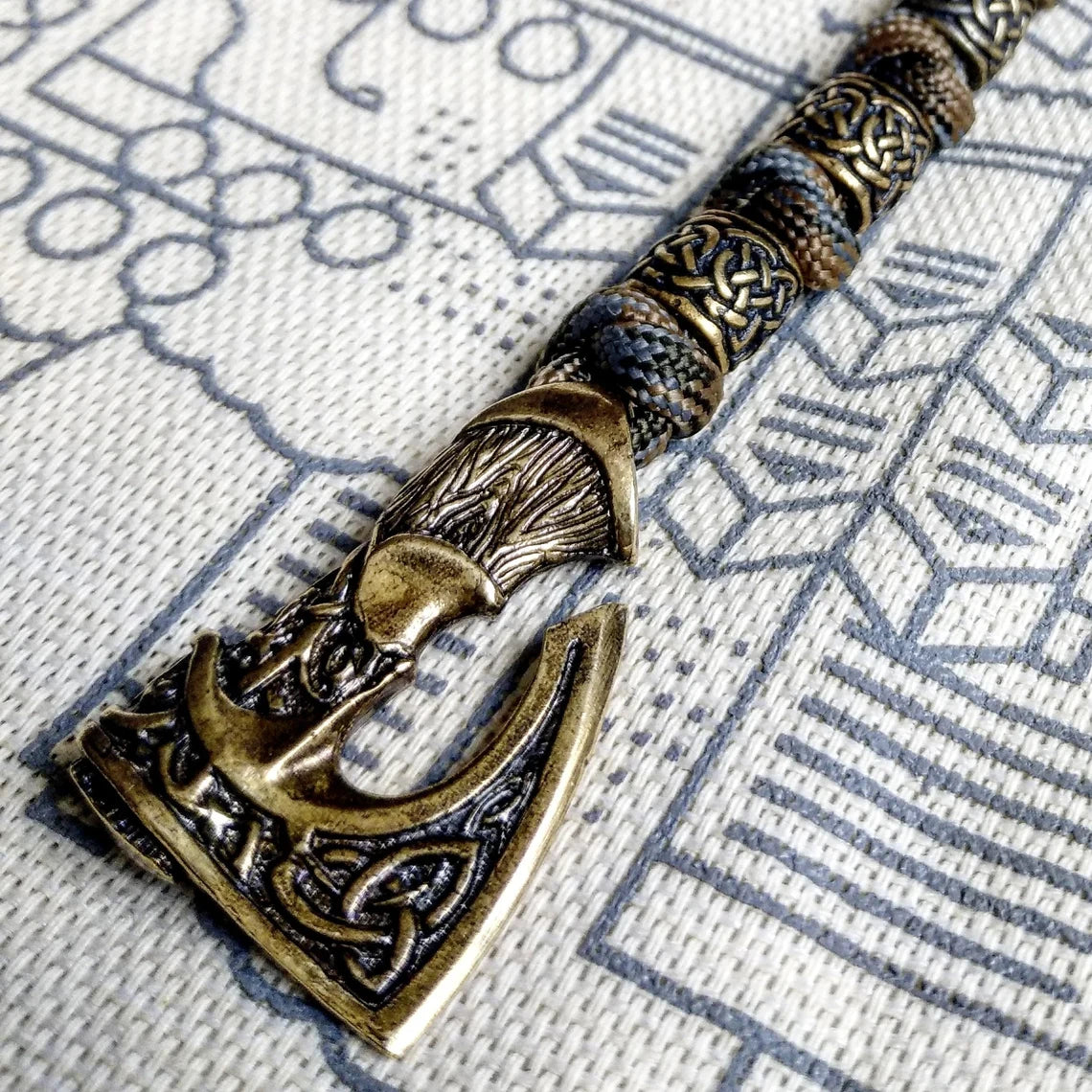 Viking bracelet made of paracord, Celtic knots and original beads made of brass with the image of ancient Scandinavian patterns. Mens style.