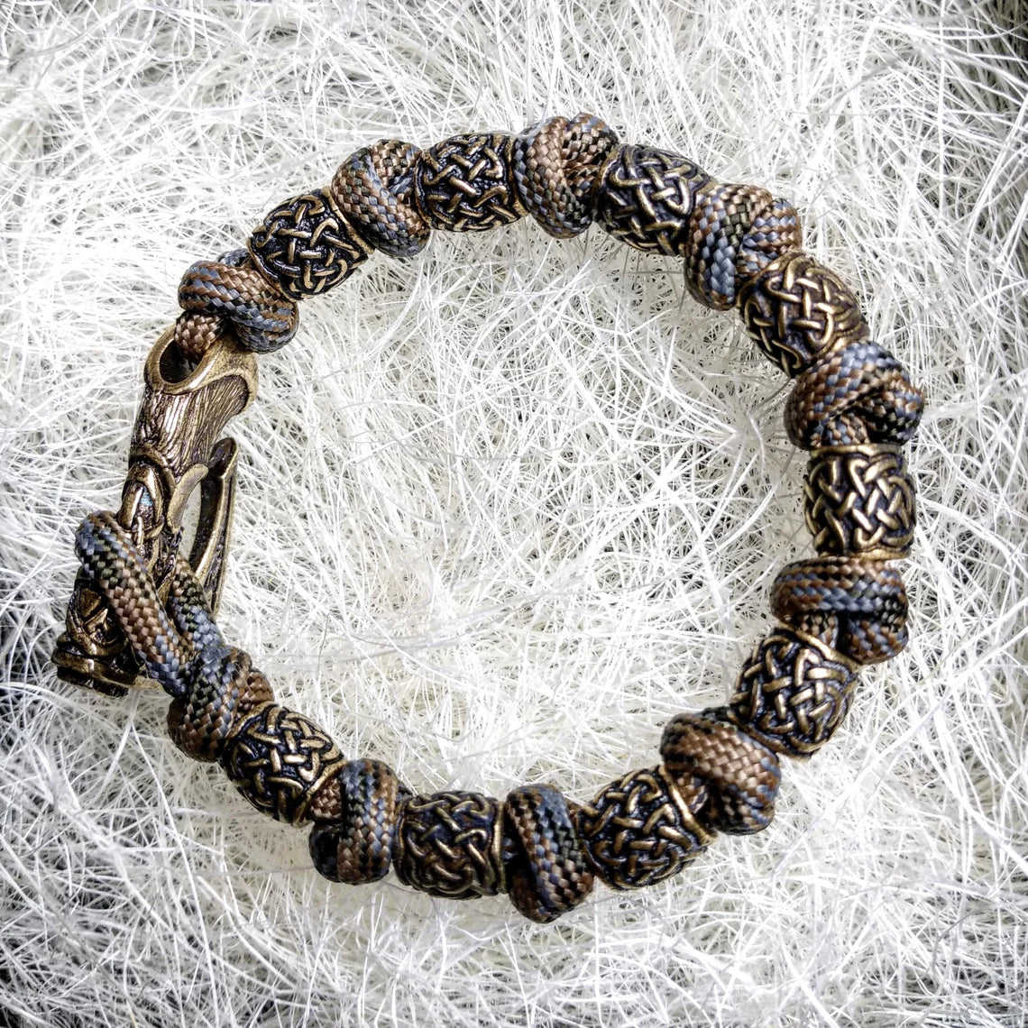 Viking bracelet made of paracord, Celtic knots and original beads made of brass with the image of ancient Scandinavian patterns. Mens style.