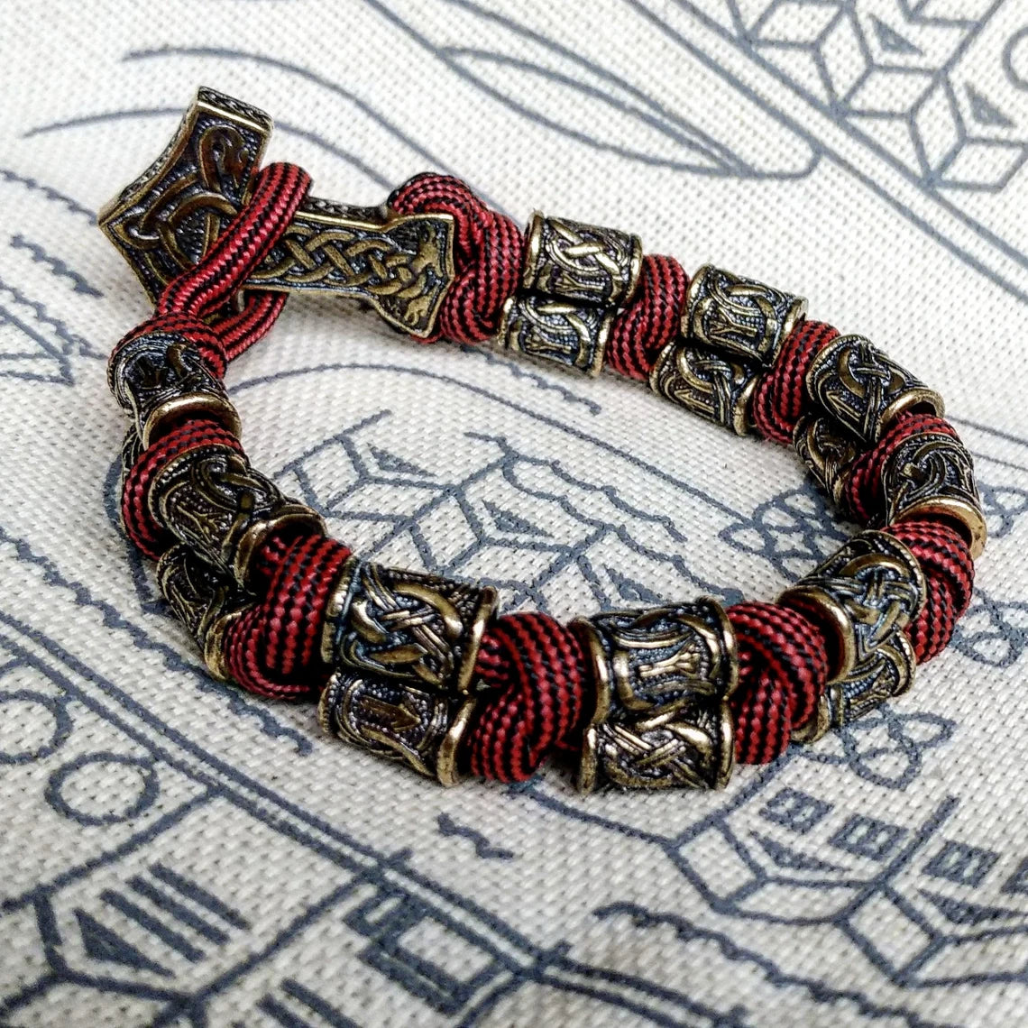 Runic bracelet "VIKING" from a paracord with a clasp "THOR'S HAMMER". Runes "teyvaz" and "algiz". Viking style.