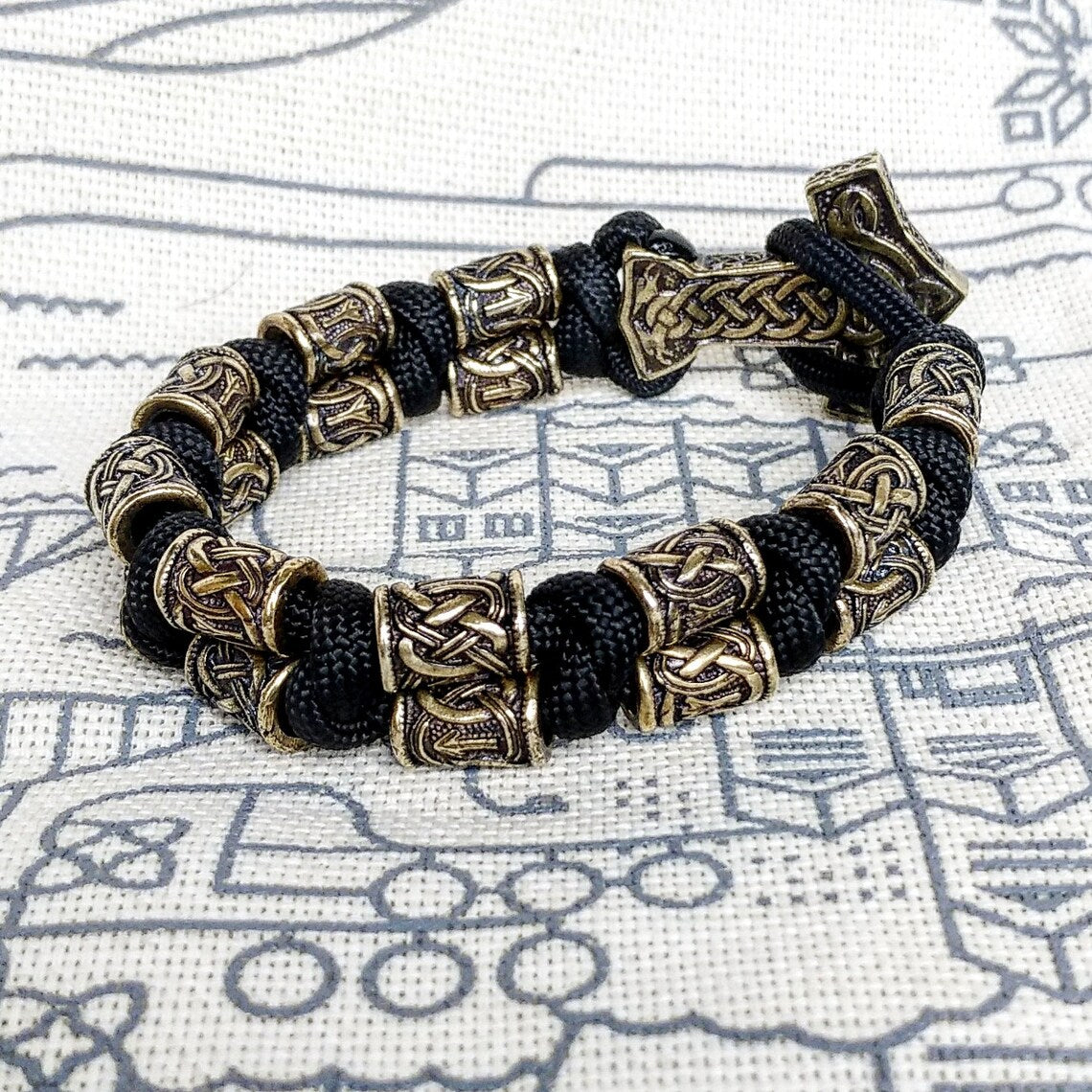 Runic bracelet "VIKING" from a paracord with a clasp "THOR'S HAMMER". Runes "teyvaz" and "algiz". Viking style.