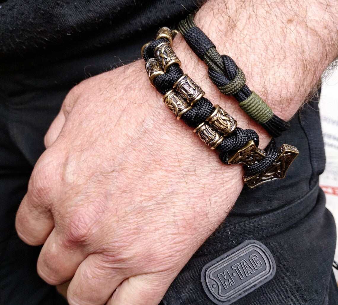 Runic bracelet "VIKING" from a paracord with a clasp "THOR'S HAMMER". Runes "teyvaz" and "algiz". Viking style.