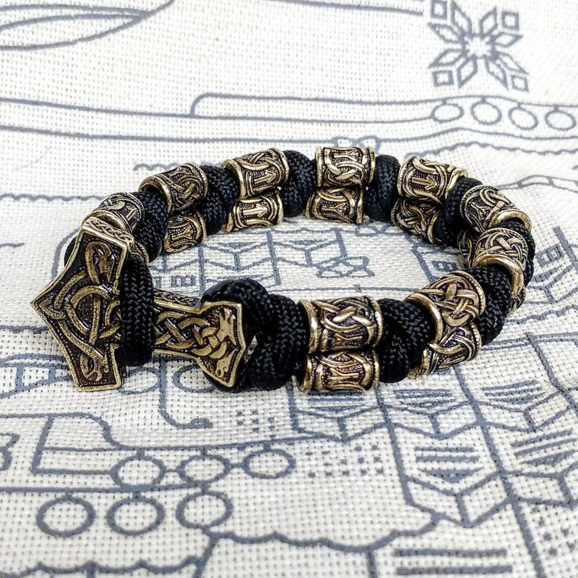 Runic bracelet "VIKING" from a paracord with a clasp "THOR'S HAMMER". Runes "teyvaz" and "algiz". Viking style.