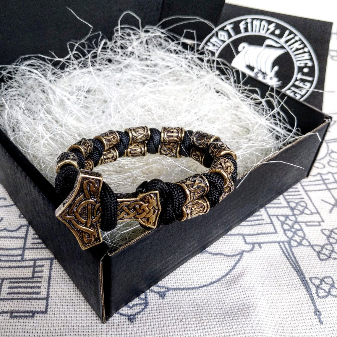 Runic bracelet "VIKING" from a paracord with a clasp "THOR'S HAMMER". Runes "teyvaz" and "algiz". Viking style.