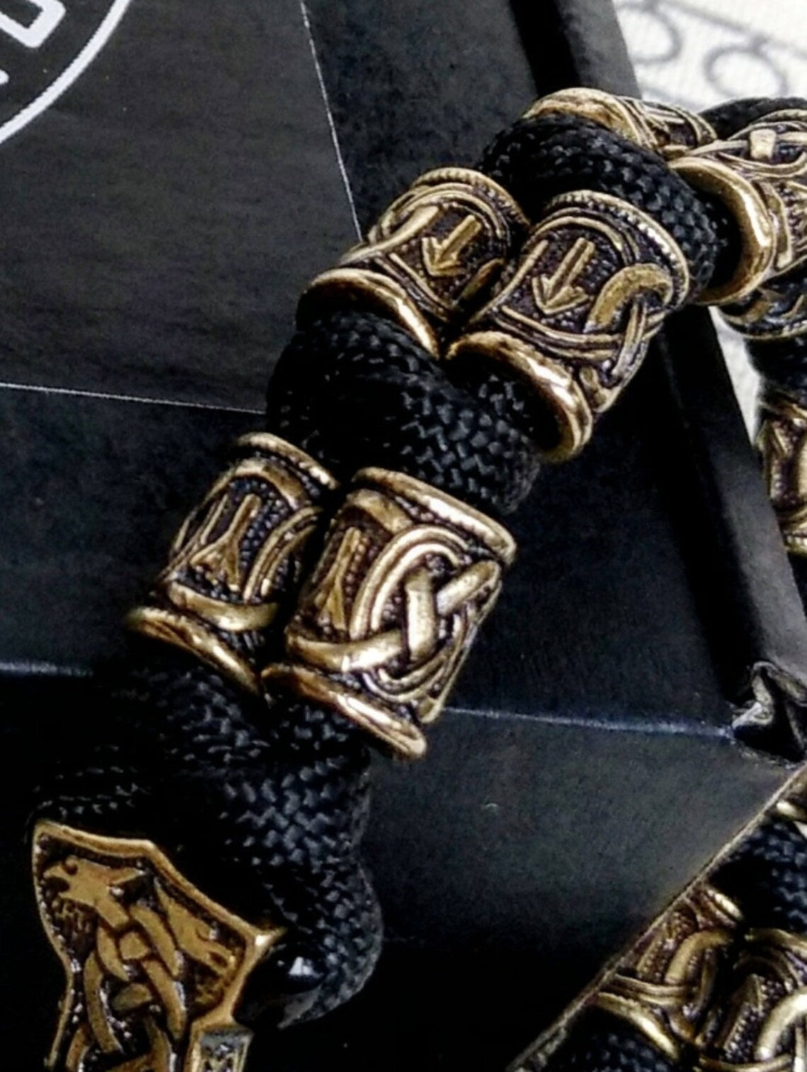 Runic bracelet "VIKING" from a paracord with a clasp "THOR'S HAMMER". Runes "teyvaz" and "algiz". Viking style.