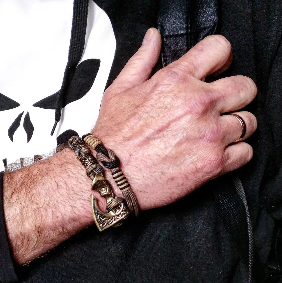 Viking bracelet made of paracord, Celtic knots and original beads made of brass with the image of ancient Scandinavian patterns. Mens style.