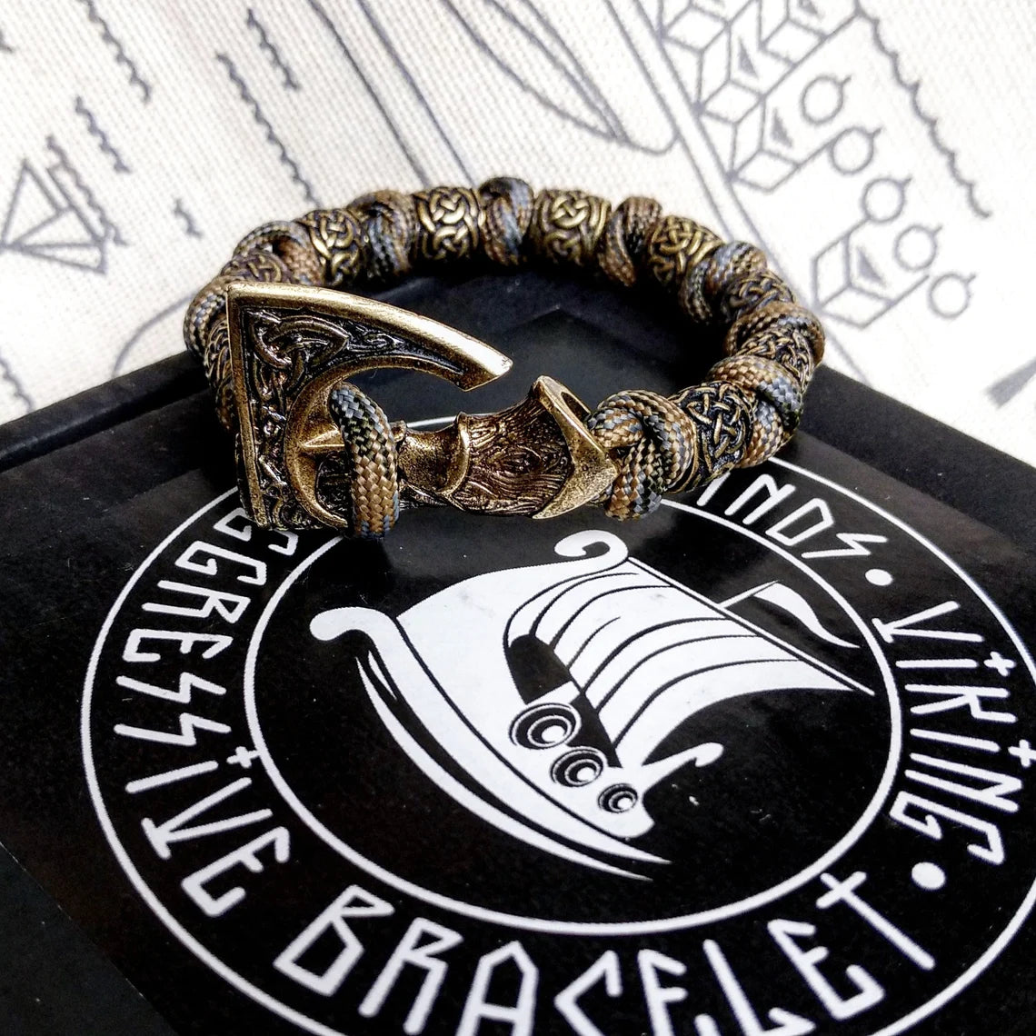 Viking bracelet made of paracord, Celtic knots and original beads made of brass with the image of ancient Scandinavian patterns. Mens style.