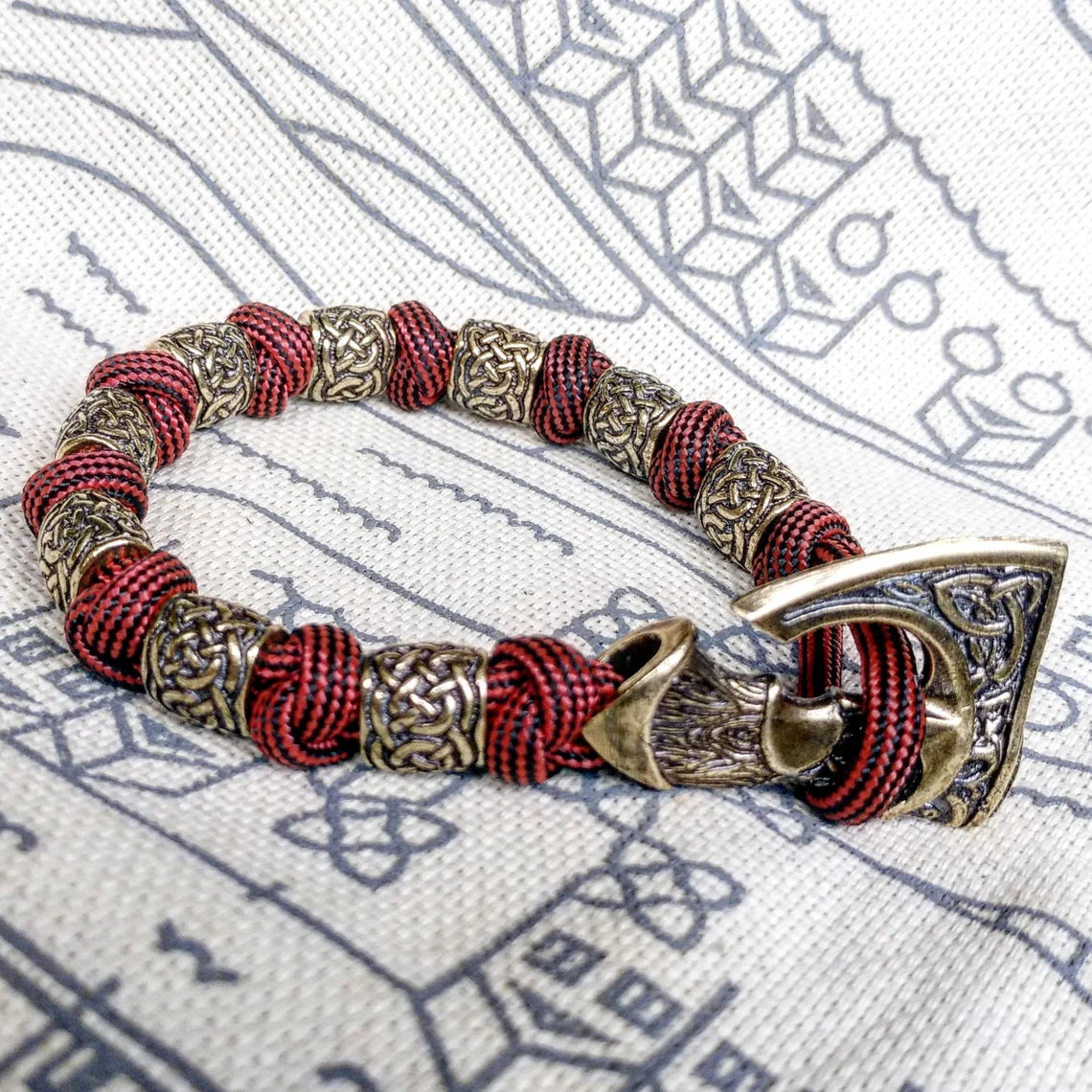 Viking bracelet made of paracord, Celtic knots and original beads made of brass with the image of ancient Scandinavian patterns. Mens style.