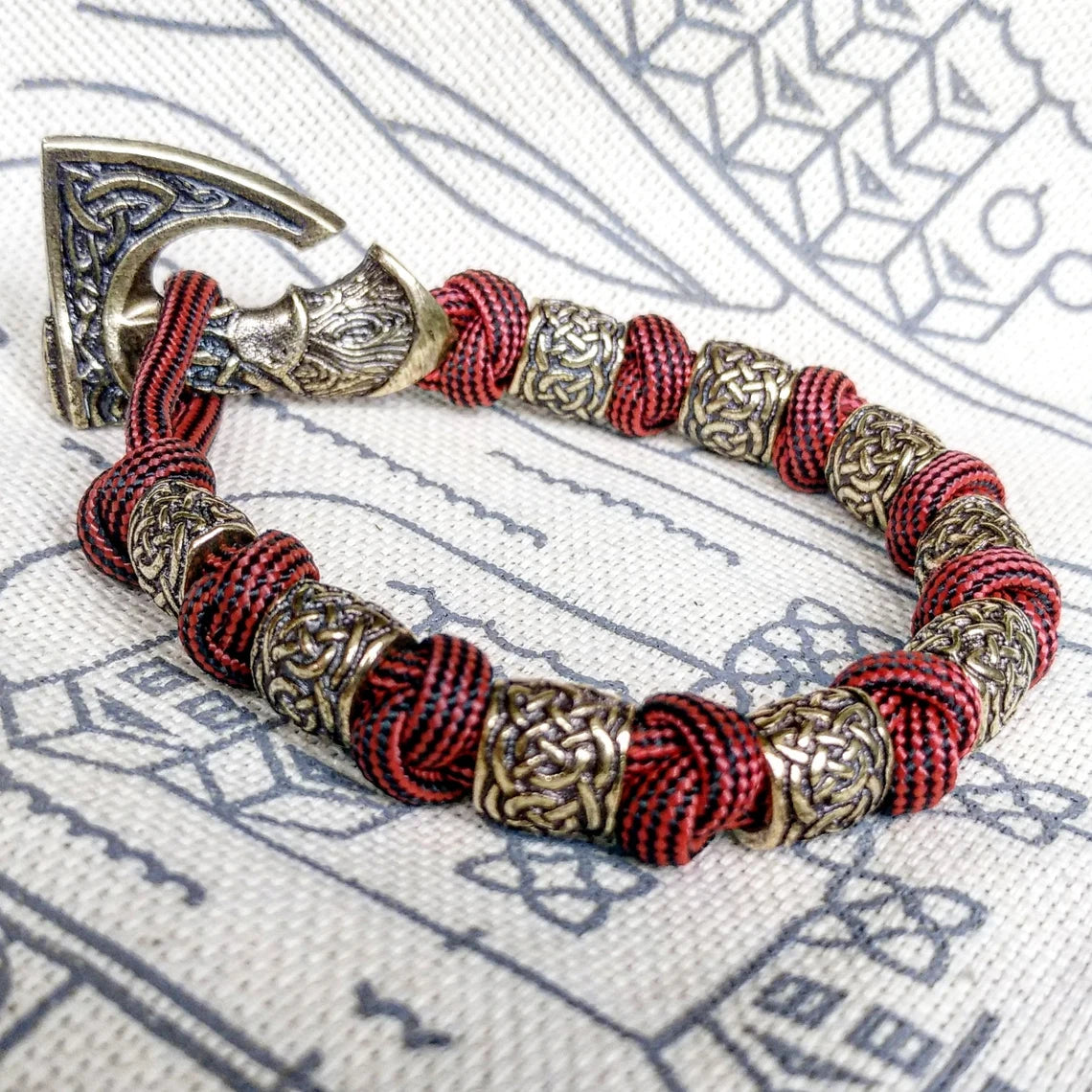 Viking bracelet made of paracord, Celtic knots and original beads made of brass with the image of ancient Scandinavian patterns. Mens style.