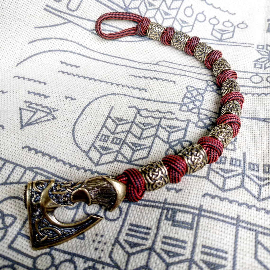 Viking bracelet made of paracord, Celtic knots and original beads made of brass with the image of ancient Scandinavian patterns. Mens style.