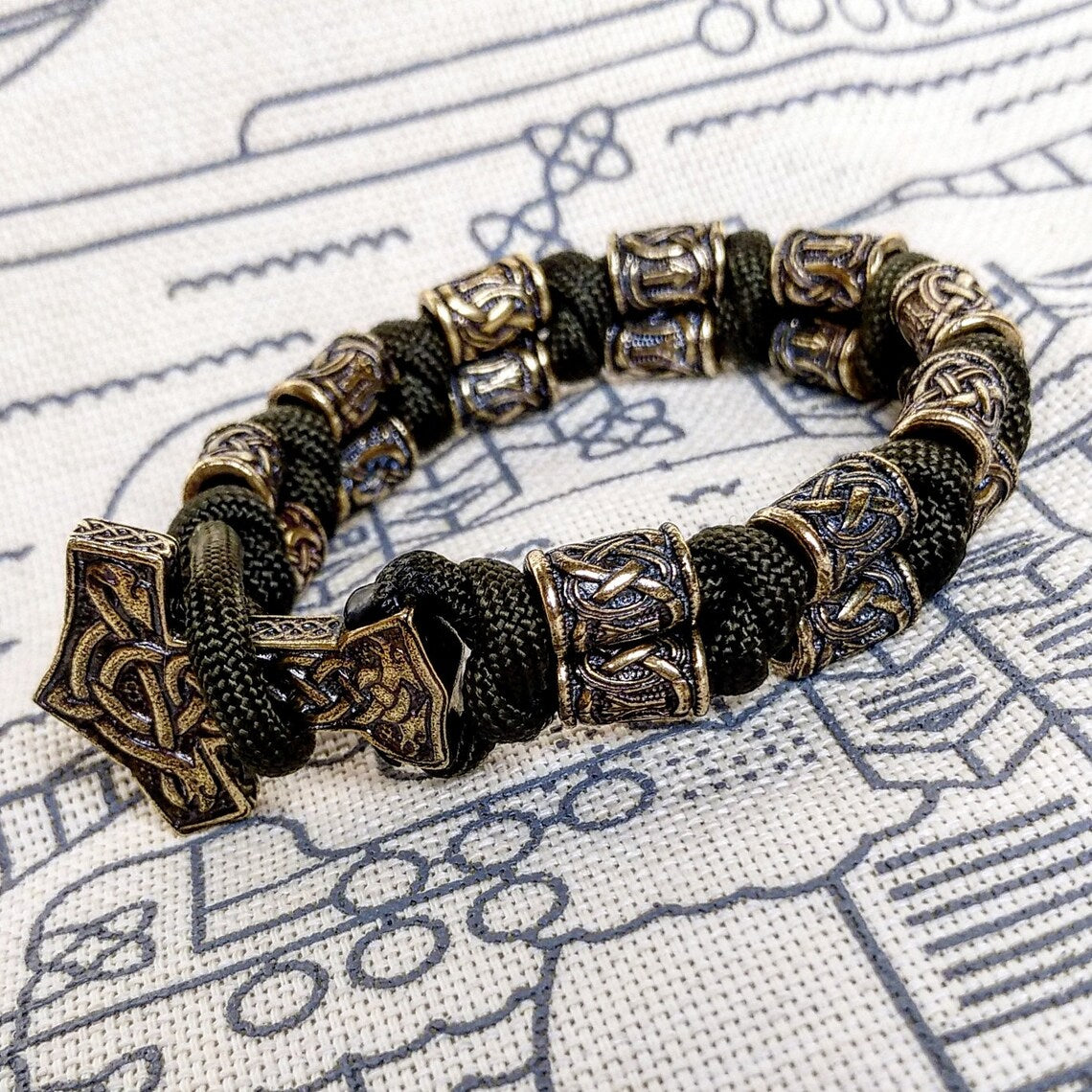 Runic bracelet "VIKING" from a paracord with a clasp "THOR'S HAMMER". Runes "teyvaz" and "algiz". Viking style.