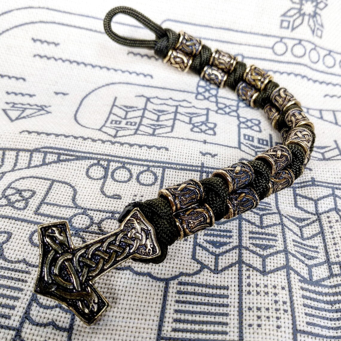 Runic bracelet "VIKING" from a paracord with a clasp "THOR'S HAMMER". Runes "teyvaz" and "algiz". Viking style.