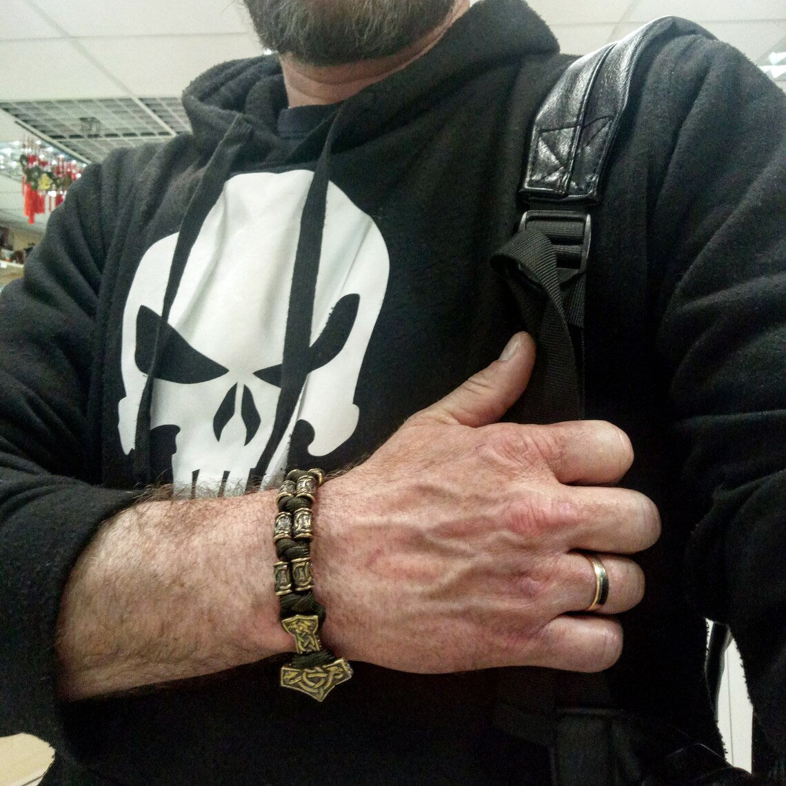 Runic bracelet "VIKING" from a paracord with a clasp "THOR'S HAMMER". Runes "teyvaz" and "algiz". Viking style.