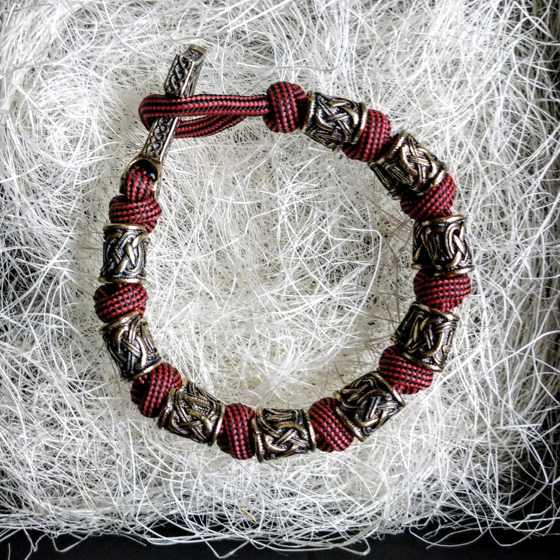 Runic bracelet "VIKING" from a paracord with a clasp "THOR'S HAMMER". Runes "teyvaz" and "algiz". Viking style.