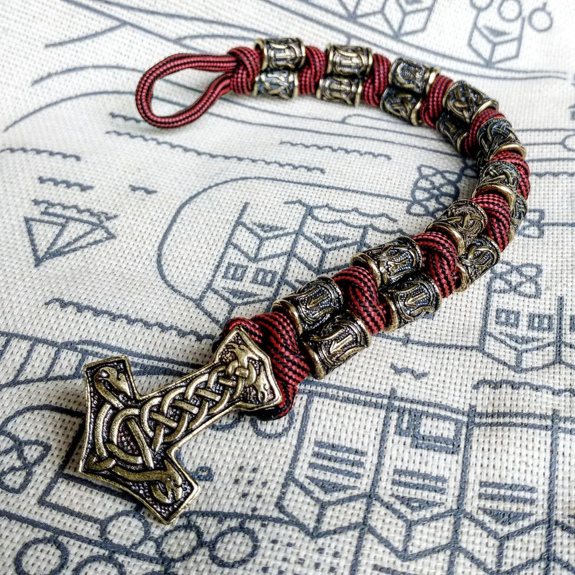 Runic bracelet "VIKING" from a paracord with a clasp "THOR'S HAMMER". Runes "teyvaz" and "algiz". Viking style.