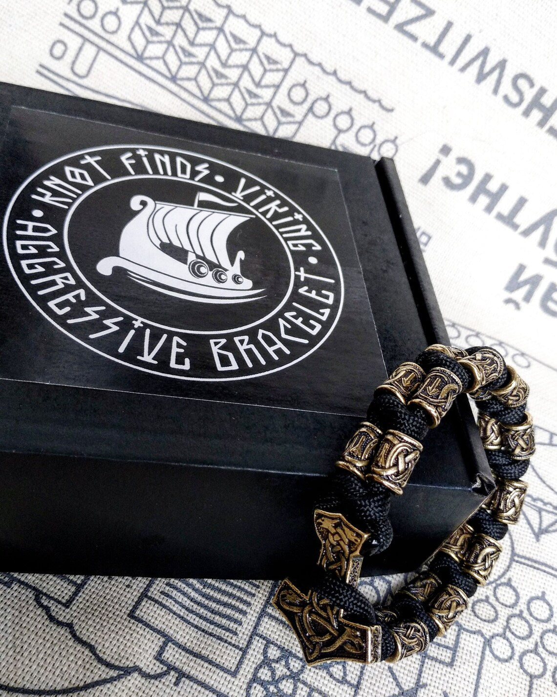 Runic bracelet "VIKING" from a paracord with a clasp "THOR'S HAMMER". Runes "teyvaz" and "algiz". Viking style.