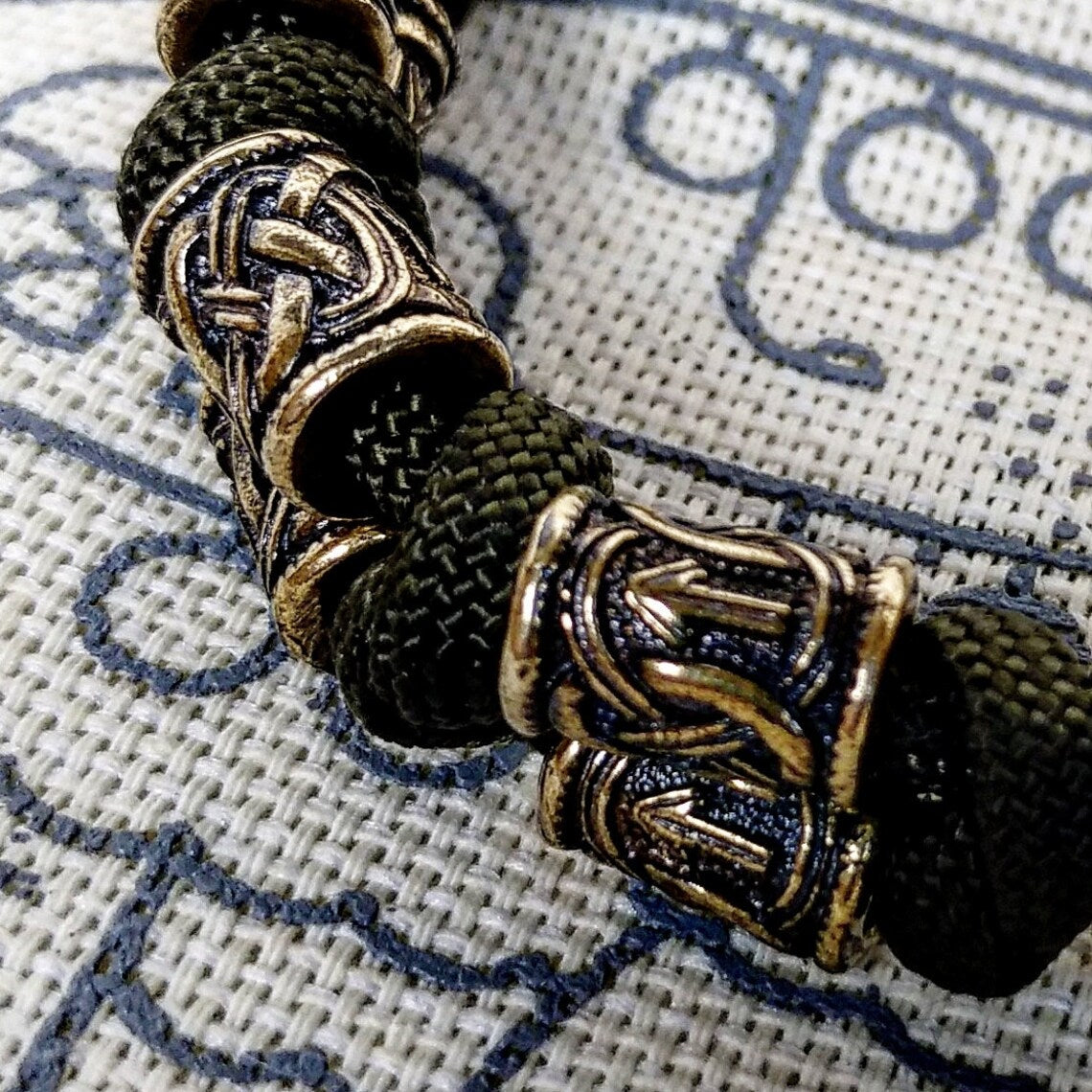 Runic bracelet "VIKING" from a paracord with a clasp "THOR'S HAMMER". Runes "teyvaz" and "algiz". Viking style.