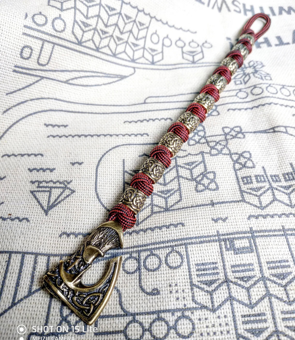Viking bracelet made of paracord, Celtic knots and original beads made of brass with the image of ancient Scandinavian patterns. Mens style.