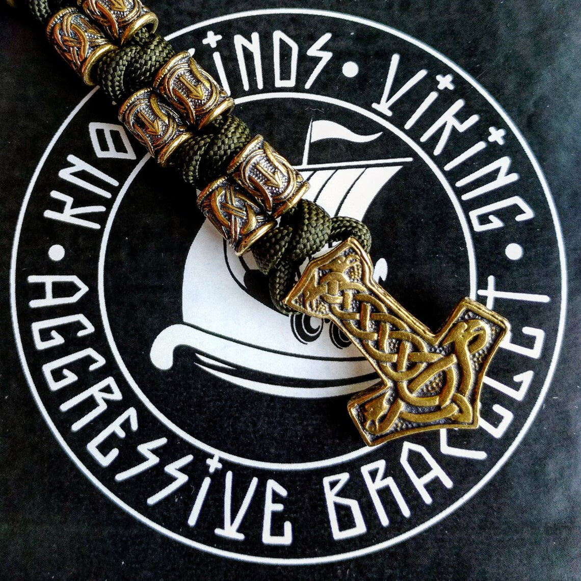 Runic bracelet "VIKING" from a paracord with a clasp "THOR'S HAMMER". Runes "teyvaz" and "algiz". Viking style.