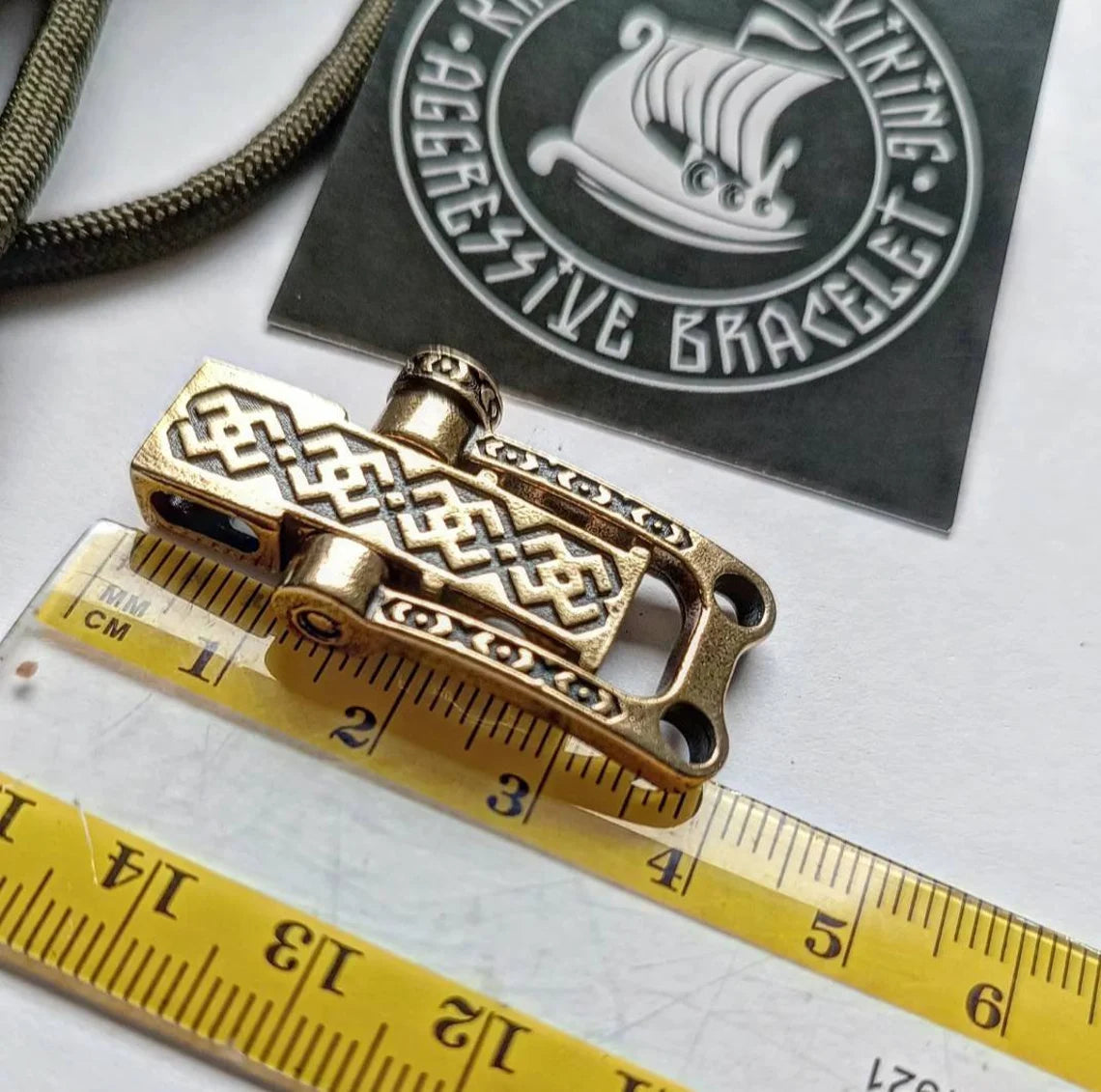 Bracelet lock. Paracord Buckles, U-shaped buckle. Viking-style paracord beads. Viking jewelry, manual casting. Scandinavian symbol.
