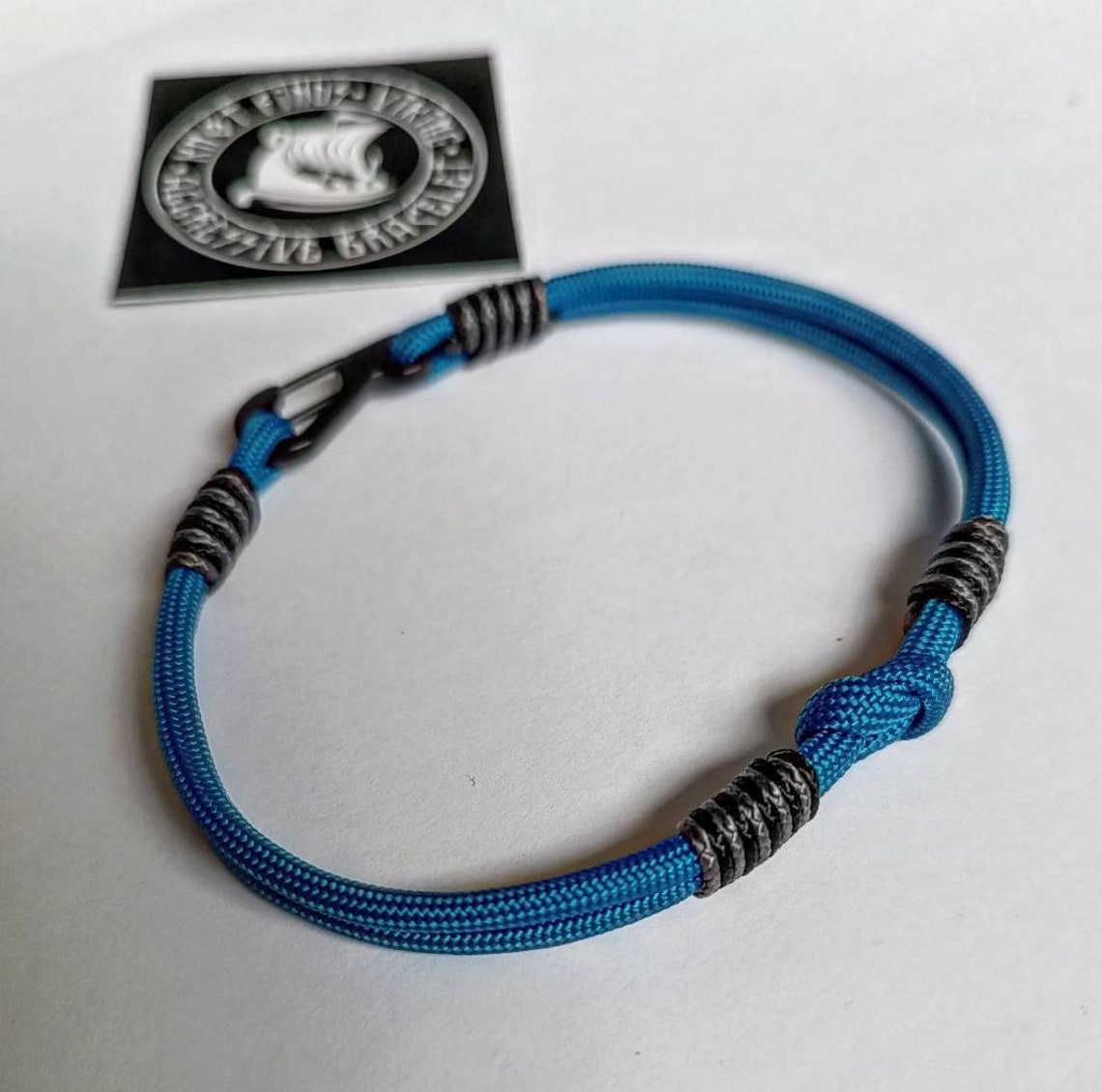 Thin military bracelet made of paracord and carabine for men. Royal blue collection. Navy style.