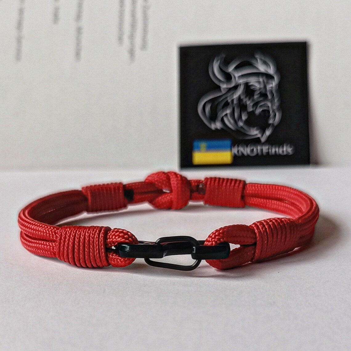 Thin legendary red bracelet. Made of paracord and carabine for men and women. Mystical style. Viking jewelry.