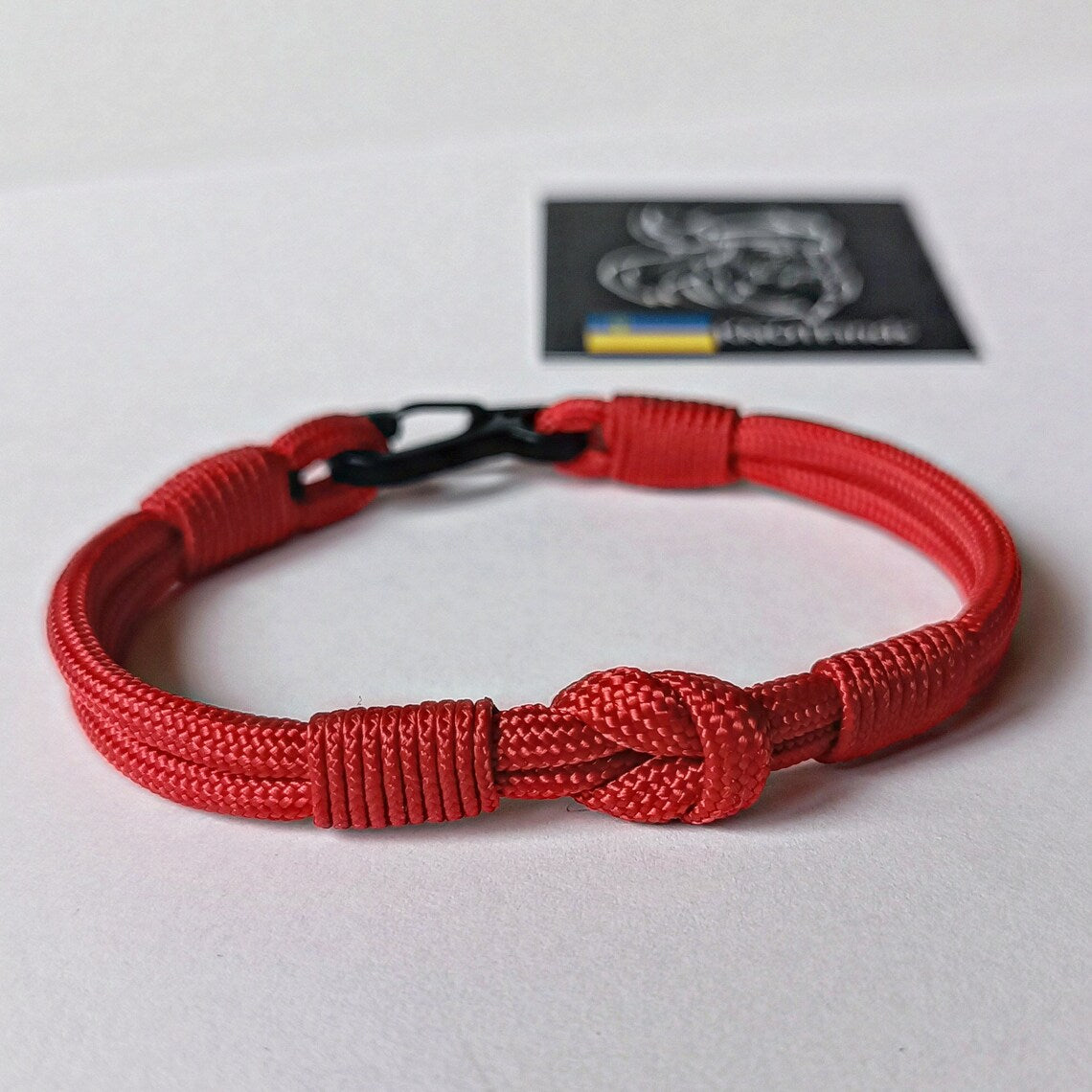 Thin legendary red bracelet. Made of paracord and carabine for men and women. Mystical style. Viking jewelry.