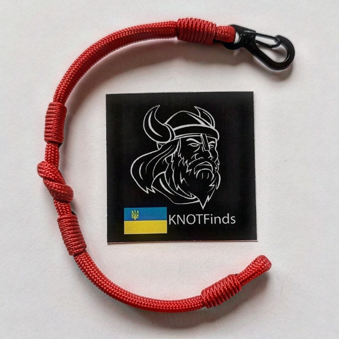 Thin legendary red bracelet. Made of paracord and carabine for men and women. Mystical style. Viking jewelry.