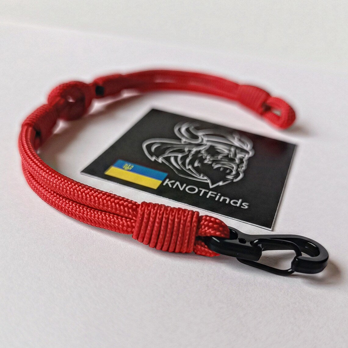 Thin legendary red bracelet. Made of paracord and carabine for men and women. Mystical style. Viking jewelry.