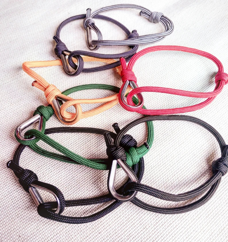 Black thin bracelet made of paracord and Celtic knots. Stylish bracelet for men and women. A gift for a surfer, diver, skydiver.