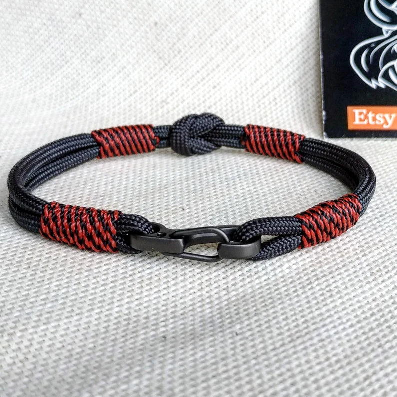 Handmade paracord bracelet made of Celtic knots, carbine and paracord. Nordic viking style.