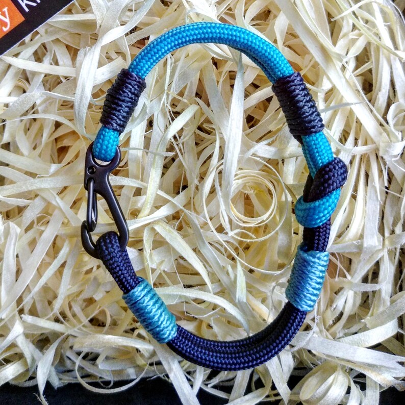 Navy blue thin Nordic paracord bangle with a carabiner. Made of parachute cord and celtic knots. Gift to a friend for his birthday.