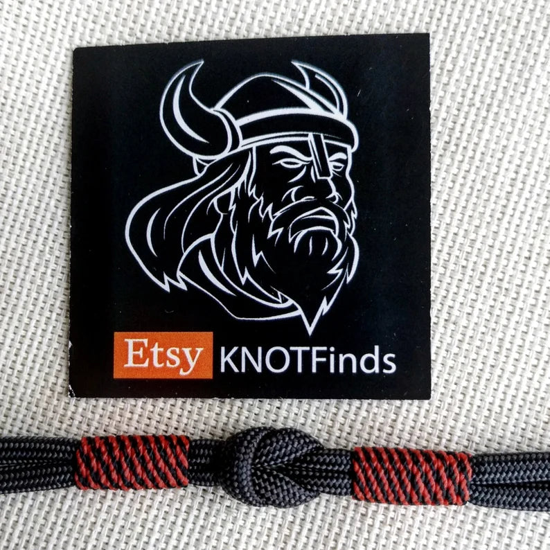 Handmade paracord bracelet made of Celtic knots, carbine and paracord. Nordic viking style.