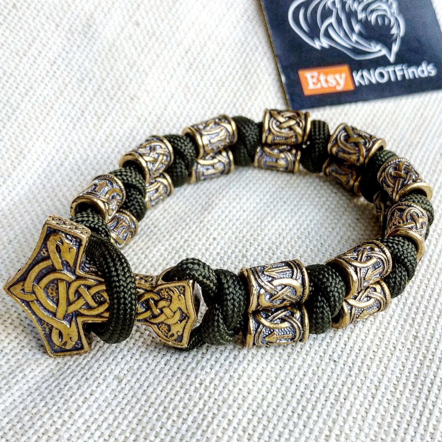 Runic bracelet "VIKING" from a paracord with a clasp "THOR'S HAMMER". Runes "teyvaz" and "algiz". Viking style.