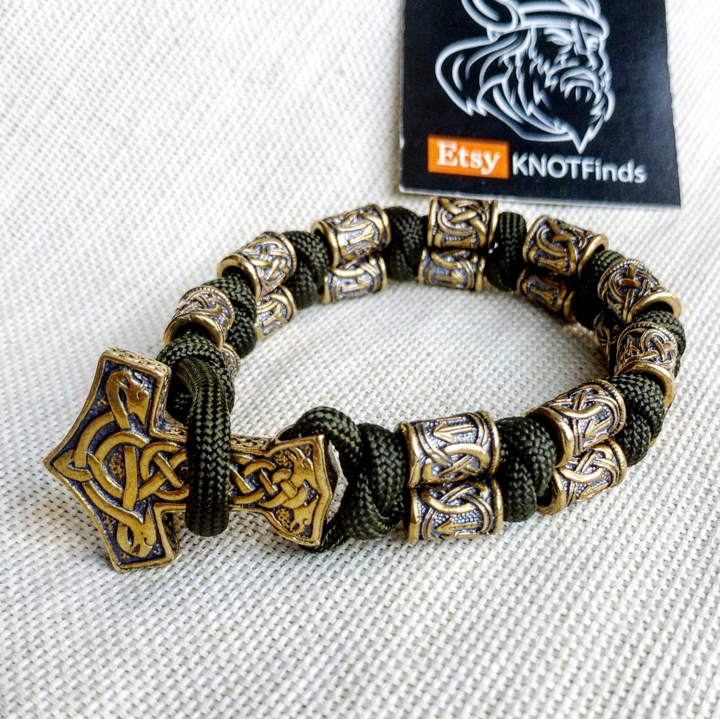 Runic bracelet "VIKING" from a paracord with a clasp "THOR'S HAMMER". Runes "teyvaz" and "algiz". Viking style.