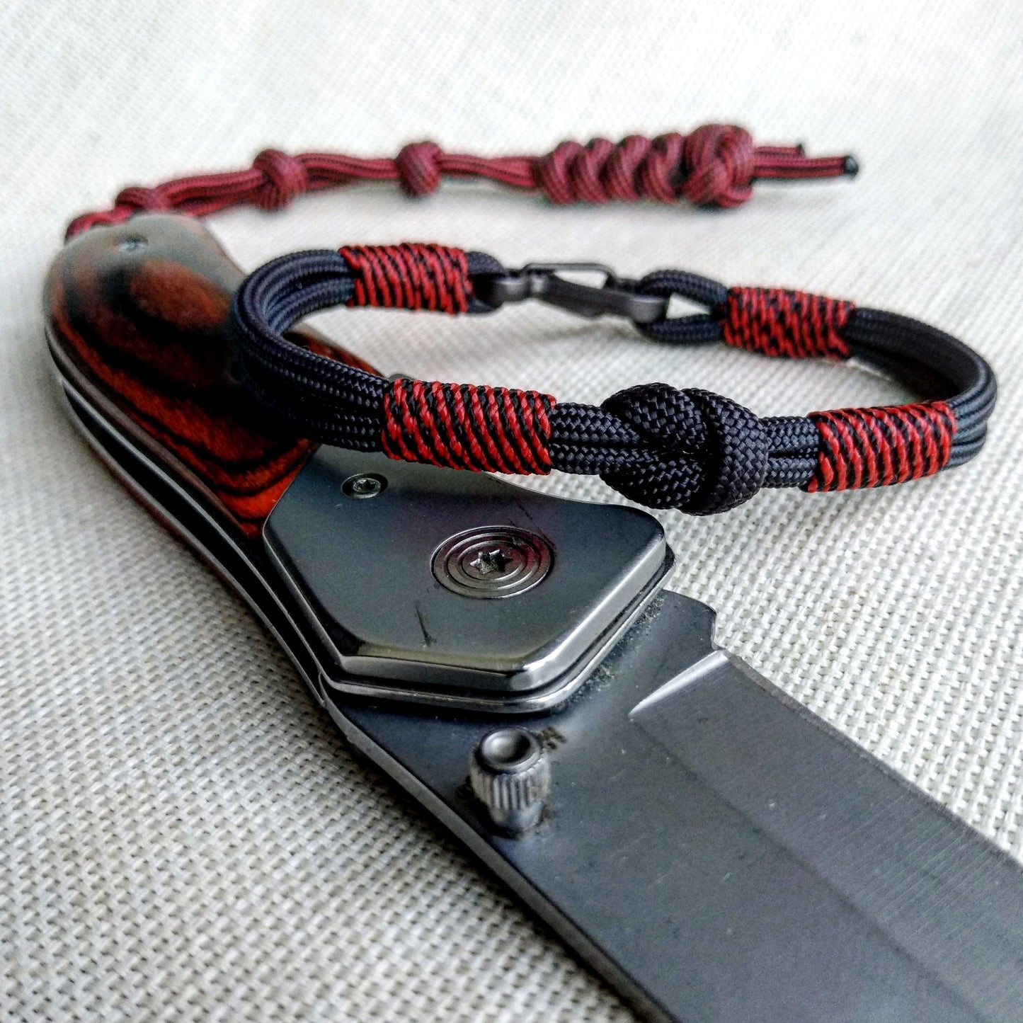 Handmade paracord bracelet made of Celtic knots, carbine and paracord. Nordic viking style.