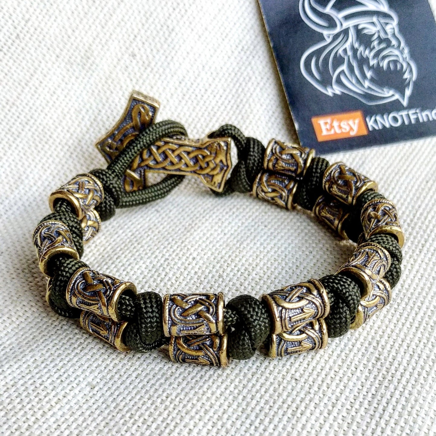 Runic bracelet "VIKING" from a paracord with a clasp "THOR'S HAMMER". Runes "teyvaz" and "algiz". Viking style.