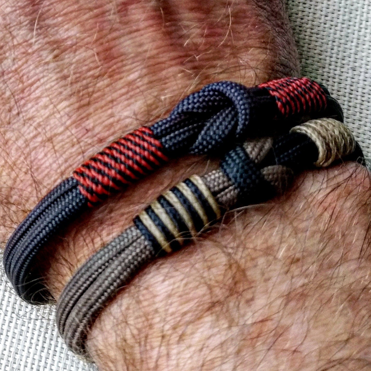 Handmade paracord bracelet made of Celtic knots, carbine and paracord. Nordic viking style.