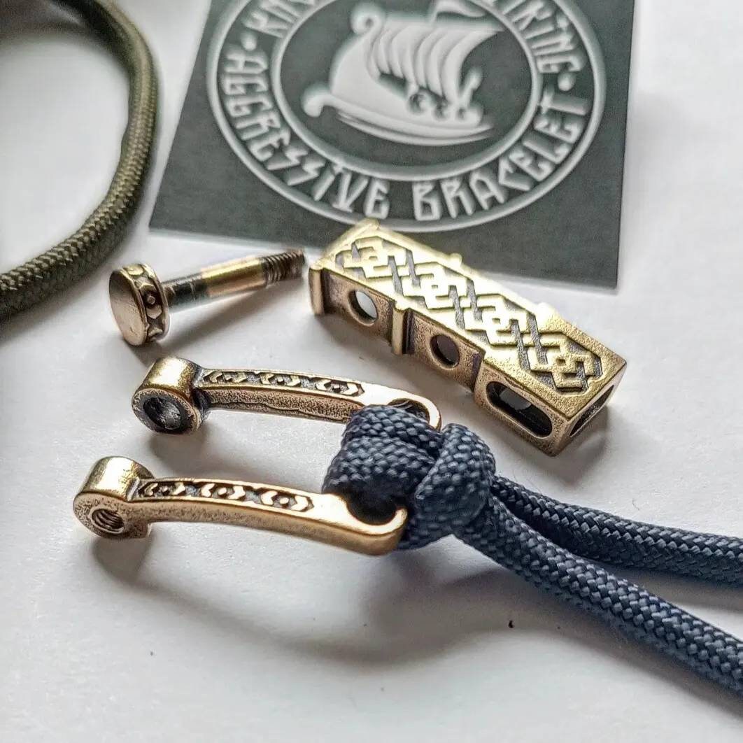 Bracelet lock. Paracord Buckles, U-shaped buckle. Viking-style paracord beads. Viking jewelry, manual casting. Scandinavian symbol.