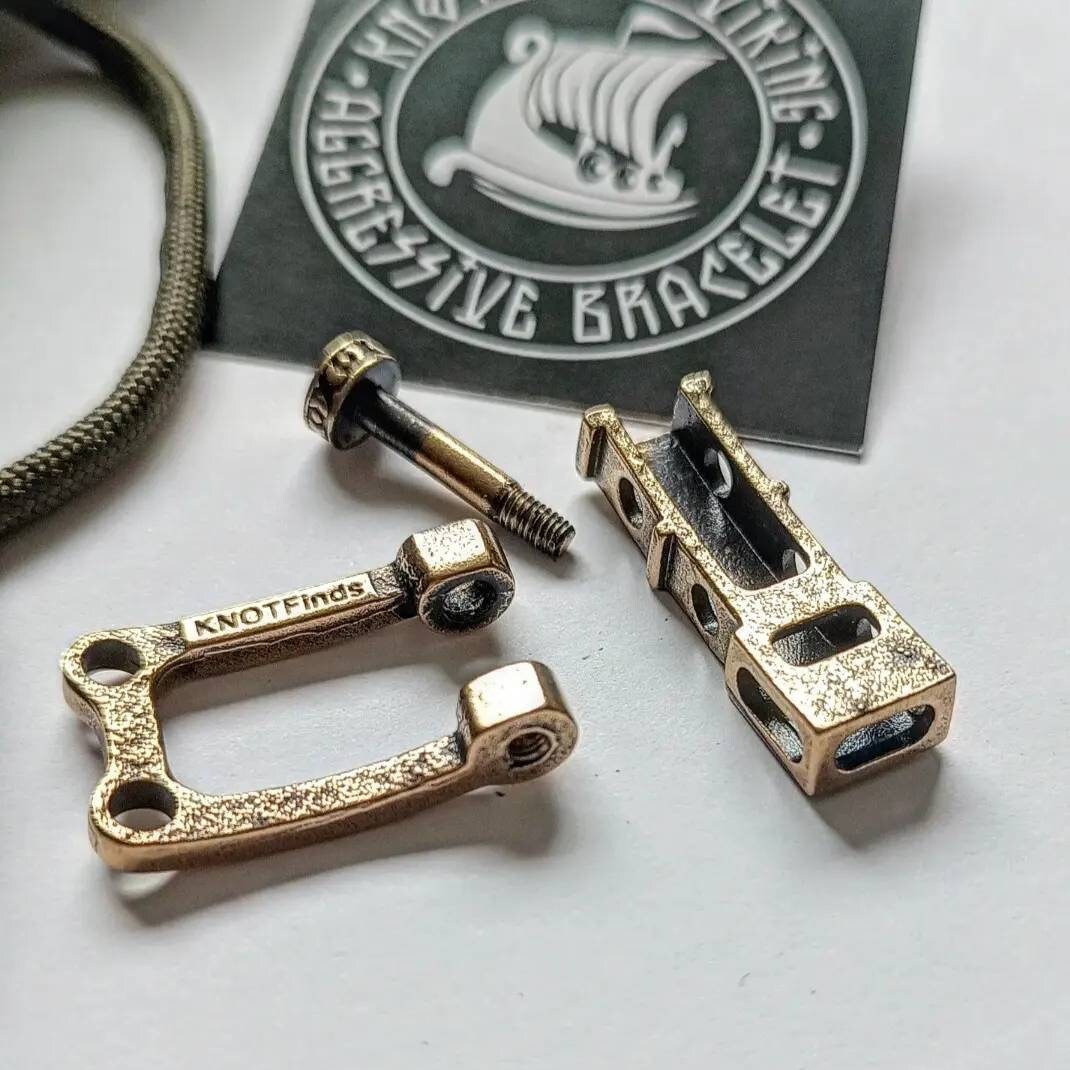 Bracelet lock. Paracord Buckles, U-shaped buckle. Viking-style paracord beads. Viking jewelry, manual casting. Scandinavian symbol.
