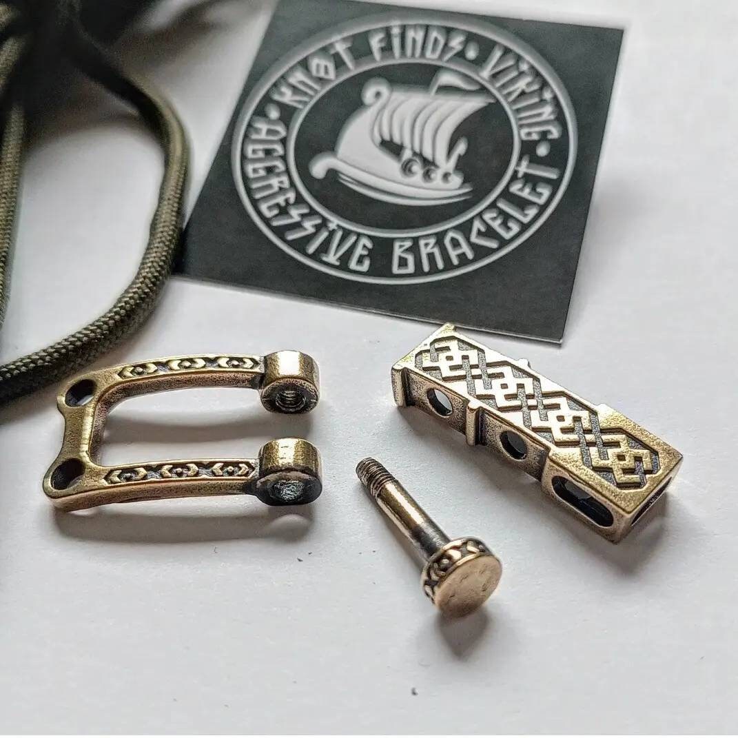 Bracelet lock. Paracord Buckles, U-shaped buckle. Viking-style paracord beads. Viking jewelry, manual casting. Scandinavian symbol.