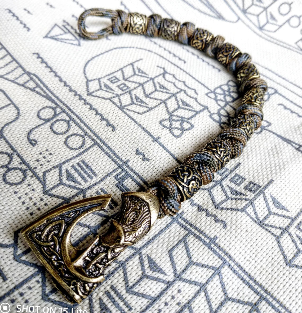 Viking bracelet made of paracord, Celtic knots and original beads made of brass with the image of ancient Scandinavian patterns. Mens style.
