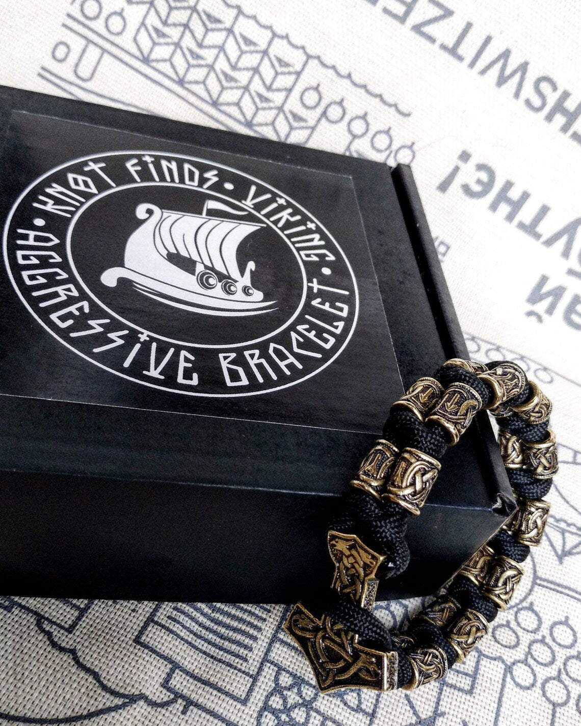 Runic bracelet "VIKING" from a paracord with a clasp "THOR'S HAMMER".  Runes  "teyvaz" and "algiz". Viking style.