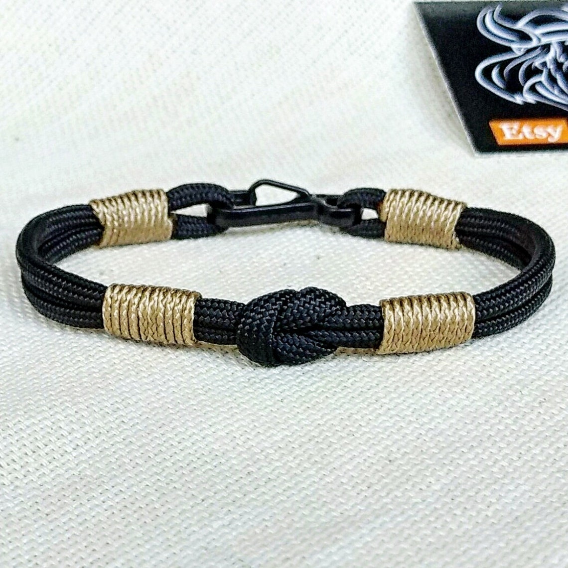 Thin Nordic paracord bangle with a carabiner.  Made of parachute cord and celtic knots.