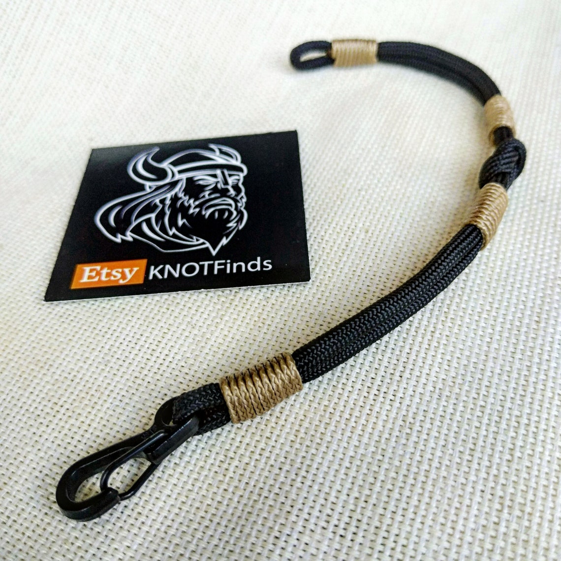 Thin Nordic paracord bangle with a carabiner.  Made of parachute cord and celtic knots.