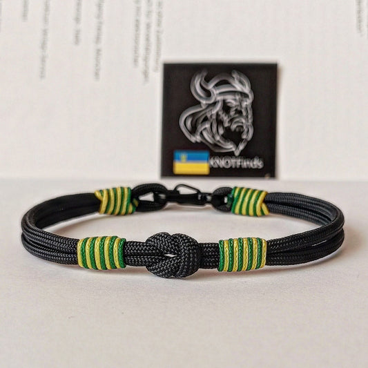 Thin paracord bracelet with a carbine. Black, green and yellow bangle. Made of parachute cord and celtic knots. Accessory for boat trips. Gift for yours friends.