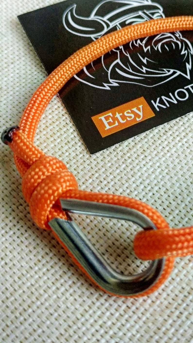 Orange thin bracelet made of paracord and Celtic knots. Stylish bracelet for men and women. A gift for a surfer, diver, skydiver.