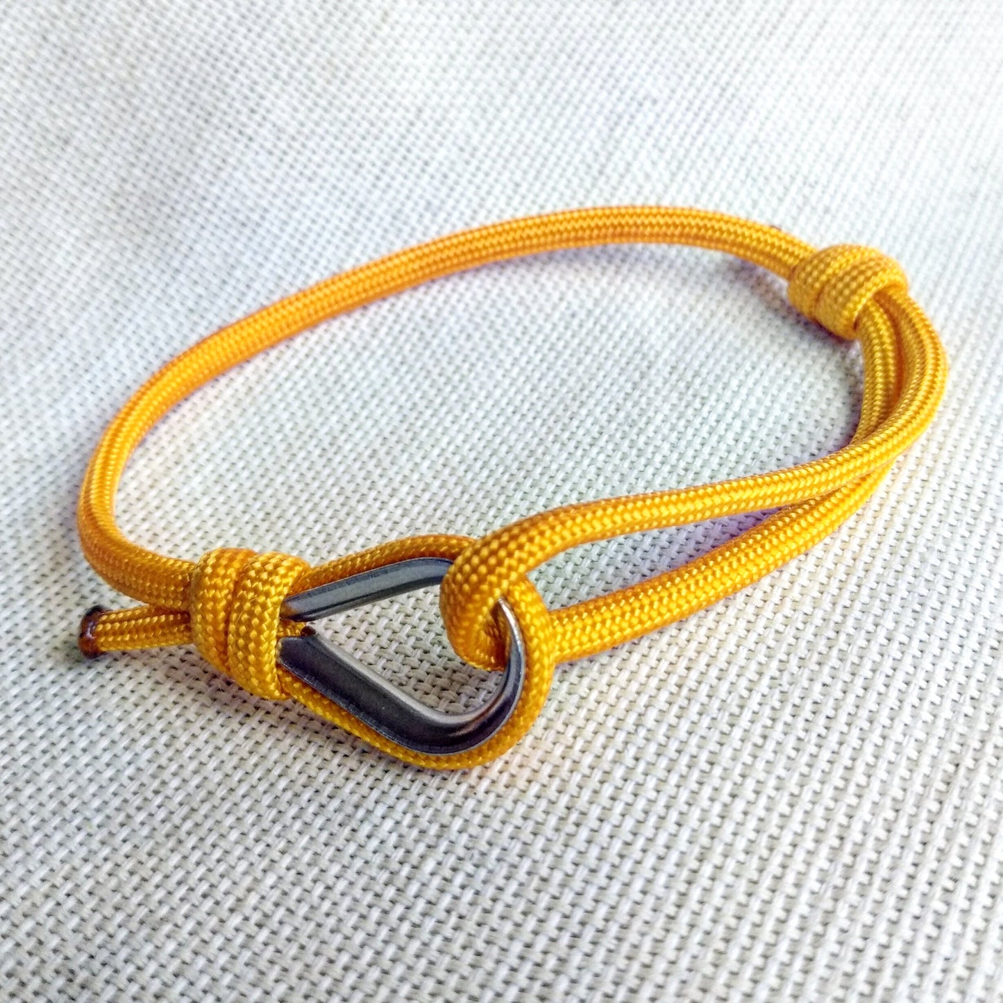 Yellow thin bracelet made of paracord and Celtic knots. Stylish bracelet for men and women. A gift for a surfer, diver, skydiver.