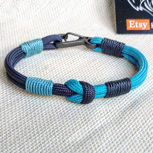 Navy blue thin Nordic paracord bangle with a carabiner.  Made of parachute cord and celtic knots.  Gift to a friend for his birthday.